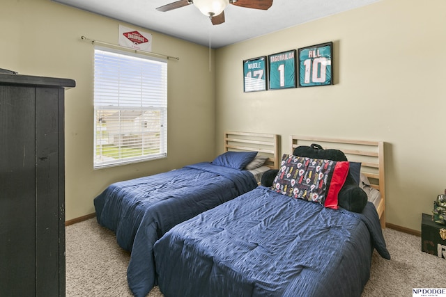 bedroom featuring a ceiling fan, baseboards, and carpet floors