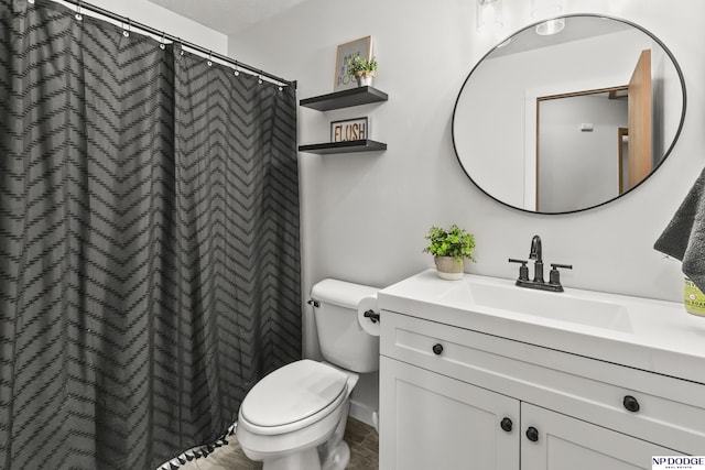 bathroom with toilet and vanity