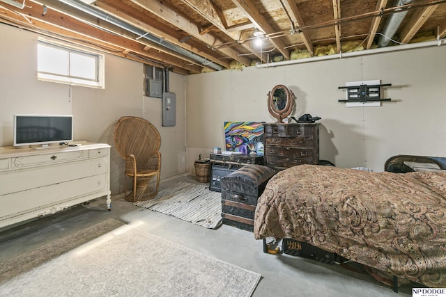bedroom featuring electric panel and concrete flooring
