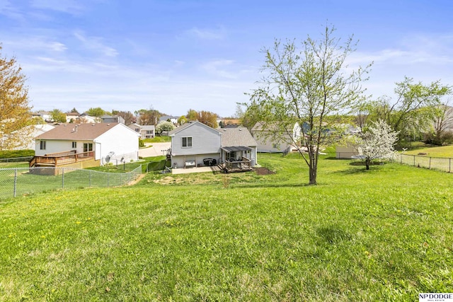 view of yard featuring a fenced backyard, a residential view, and a patio area