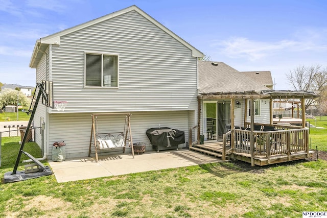 back of house featuring a pergola, a shingled roof, fence, a yard, and a wooden deck