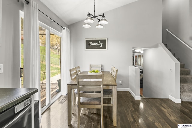 dining area featuring stairway, vaulted ceiling, wood finished floors, baseboards, and a chandelier