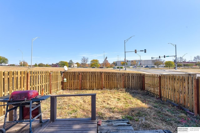 view of yard with a fenced backyard and a deck