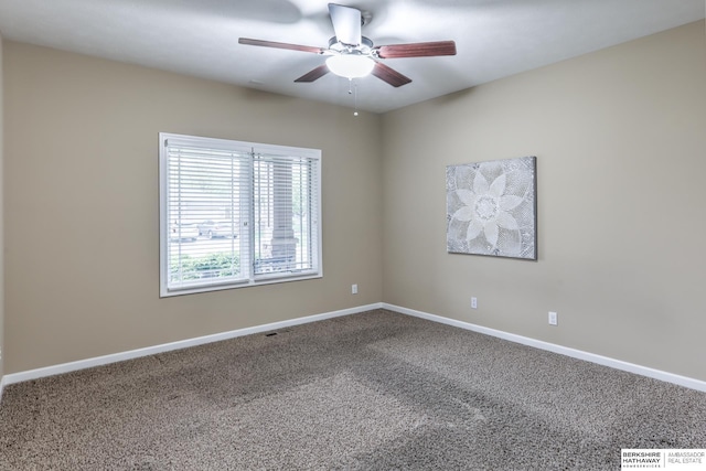 carpeted spare room with baseboards and ceiling fan