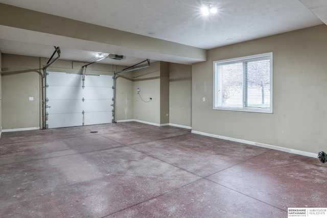 garage with baseboards and a garage door opener
