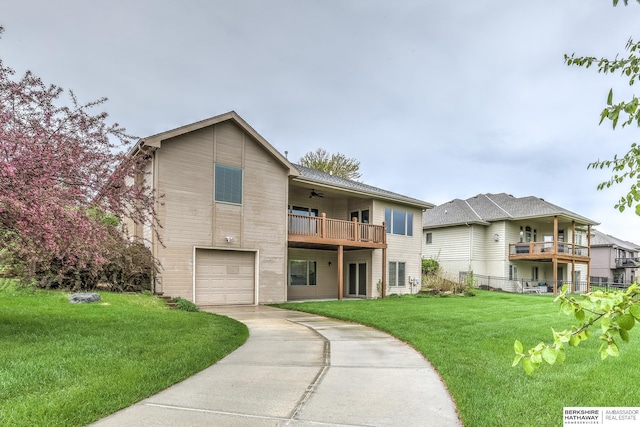 view of front of property with driveway, a ceiling fan, a front yard, a balcony, and an attached garage