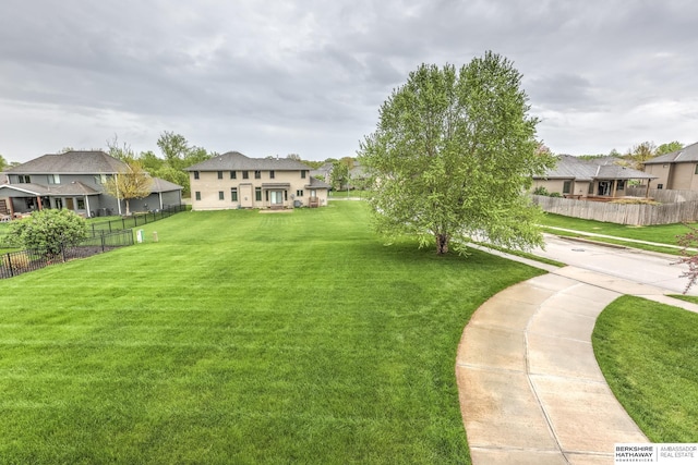 view of yard with fence and a residential view