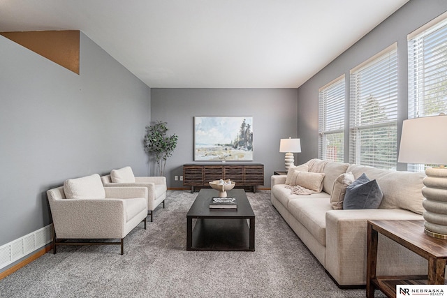 carpeted living room featuring baseboards, plenty of natural light, and visible vents