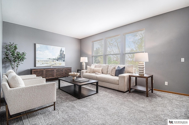 carpeted living room featuring baseboards