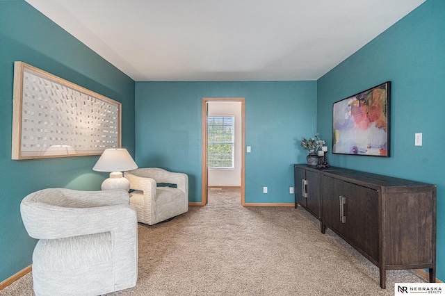 sitting room featuring baseboards and carpet