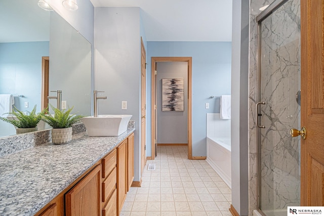 bathroom featuring vanity, a bath, a marble finish shower, and baseboards