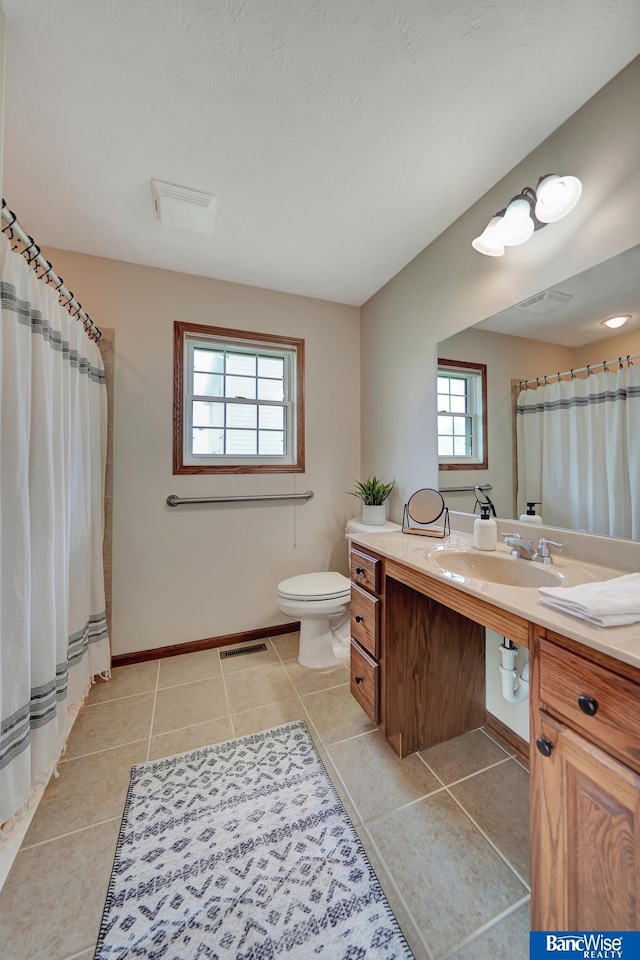 bathroom featuring toilet, tile patterned flooring, visible vents, and vanity