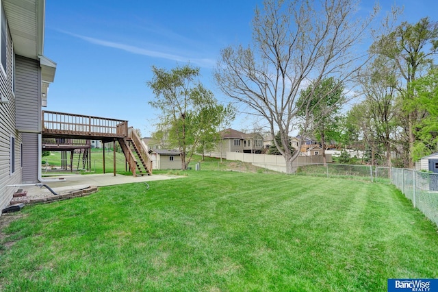 view of yard with a fenced backyard, a patio, a wooden deck, a residential view, and stairs