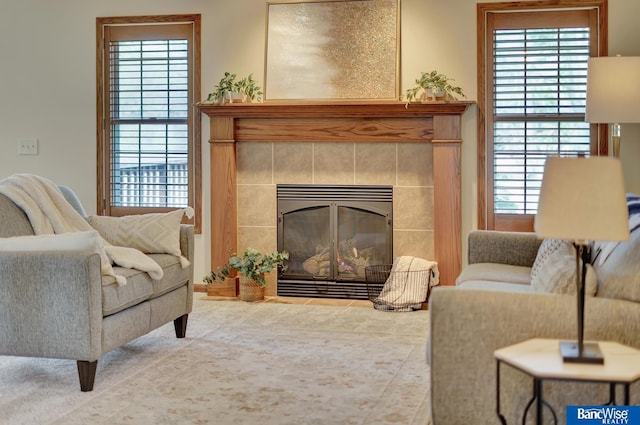 living room featuring a tiled fireplace