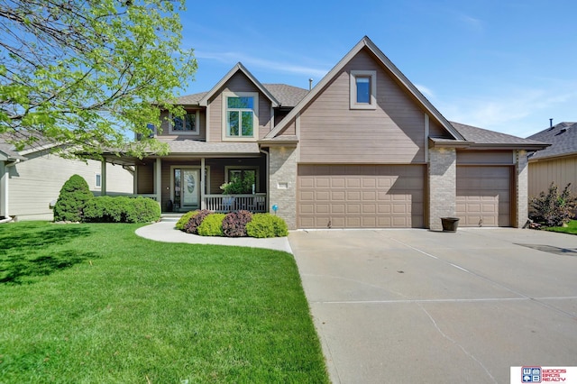 craftsman-style home featuring covered porch, driveway, a front yard, brick siding, and an attached garage