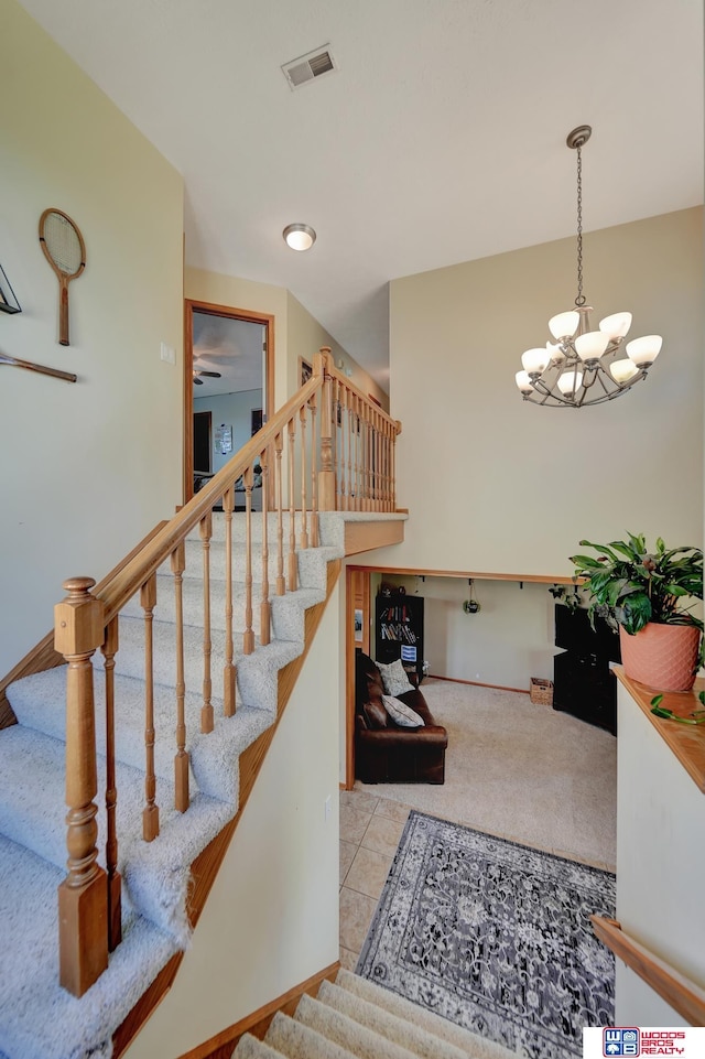 staircase with a chandelier and baseboards