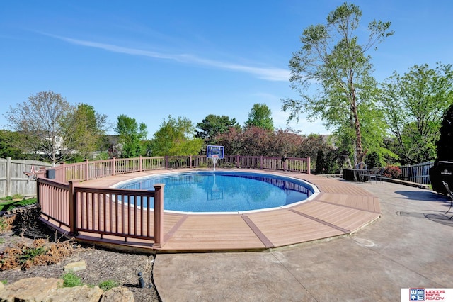 view of pool featuring fence and a patio