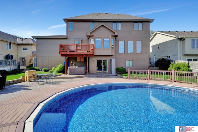 back of property with a fenced backyard, central AC unit, a patio, and a deck