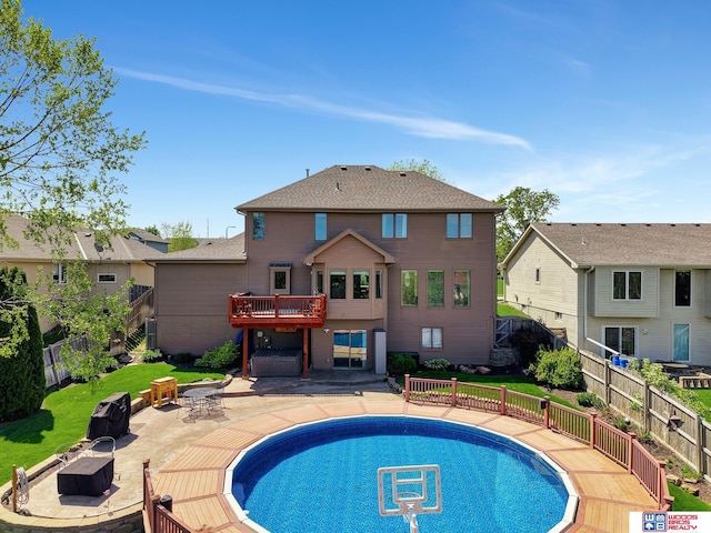 view of swimming pool with an outdoor fire pit, a patio area, and a wooden deck