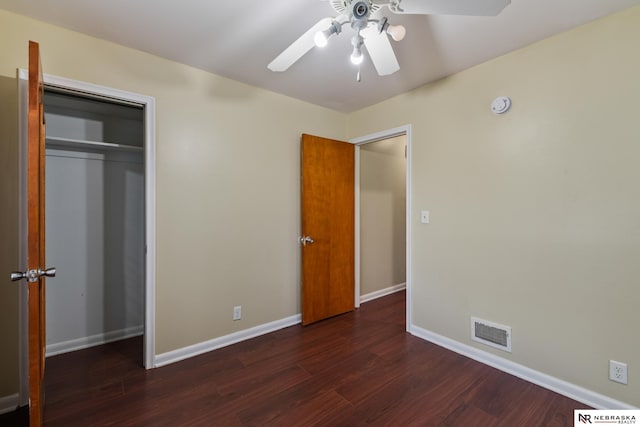 unfurnished bedroom with a ceiling fan, baseboards, wood finished floors, visible vents, and a closet