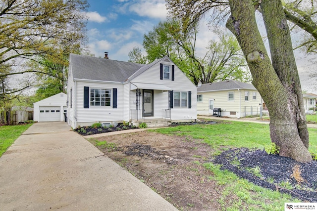 view of front of home featuring roof with shingles, a chimney, concrete driveway, an outbuilding, and a detached garage