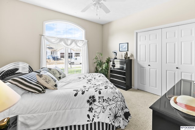 bedroom with ceiling fan, a closet, and carpet