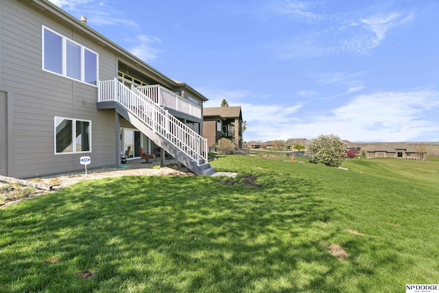 view of yard with stairway and a deck