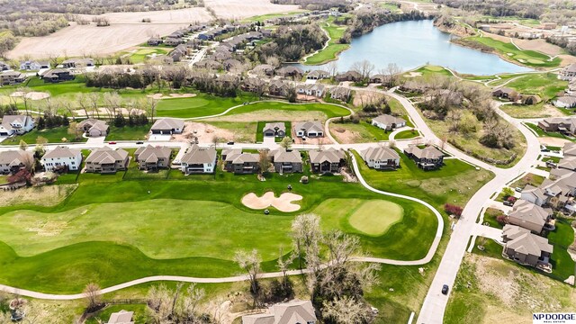 birds eye view of property featuring view of golf course, a water view, and a residential view