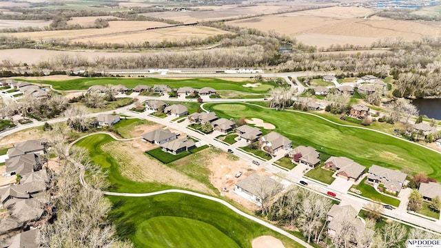 birds eye view of property with golf course view and a residential view