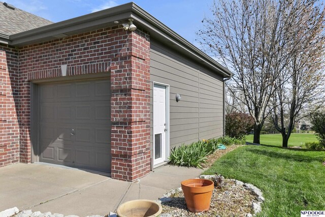 view of home's exterior with a lawn and brick siding