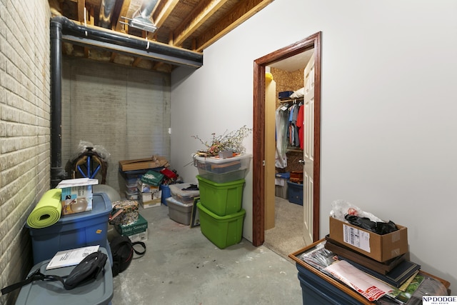 basement featuring brick wall