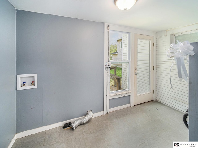 laundry area with tile patterned floors, washer hookup, laundry area, and baseboards