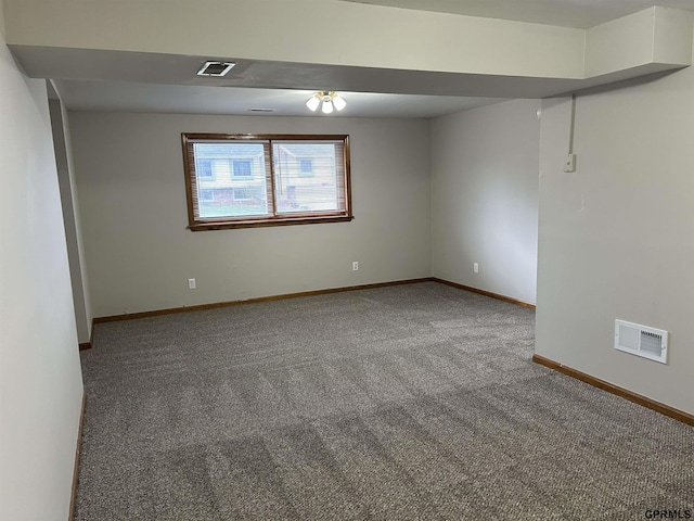 unfurnished room featuring baseboards, visible vents, and carpet flooring