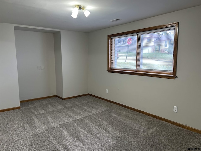 spare room with visible vents, baseboards, and carpet floors