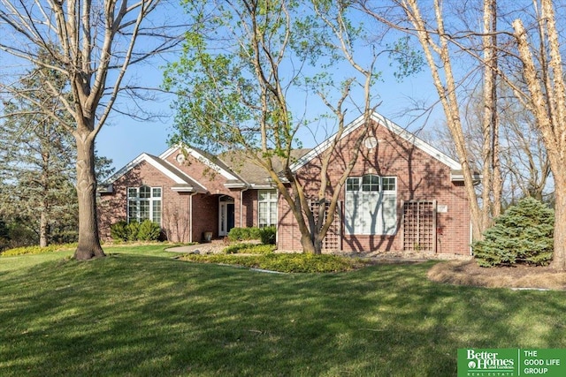 5850 Country Squire Plz, Omaha, NE 68152 - view of front of home with brick siding and a front lawn