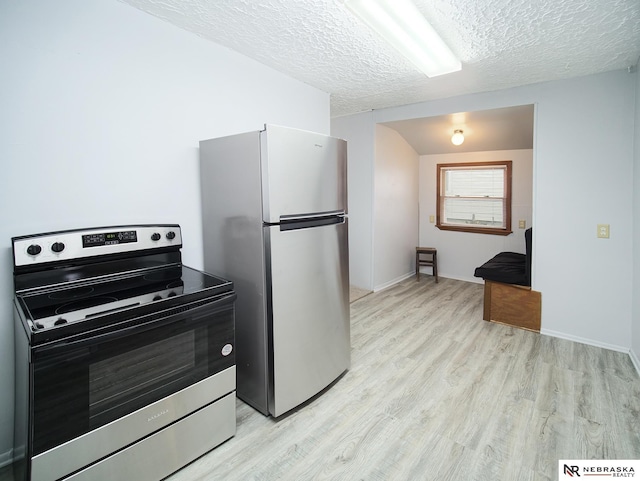 1029 Rose St, Lincoln, NE 68502 - kitchen featuring appliances with stainless steel finishes, light wood-style floors, a textured ceiling, and baseboards