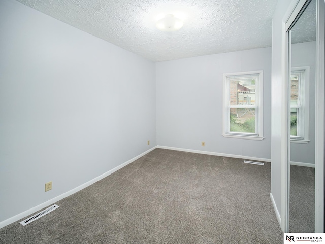 1029 Rose St, Lincoln, NE 68502 - carpeted spare room featuring a textured ceiling and baseboards