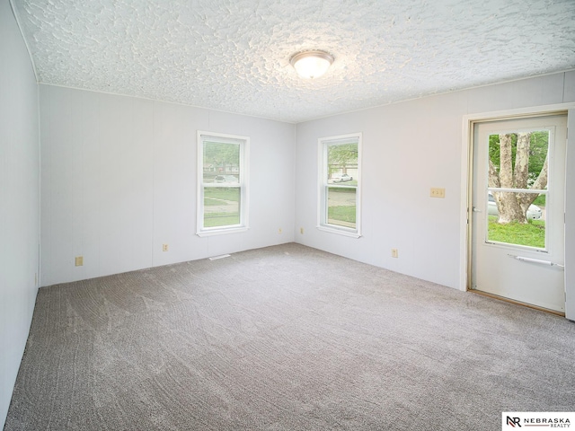 1029 Rose St, Lincoln, NE 68502 - carpeted spare room featuring a textured ceiling