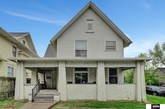2103 A St, Lincoln, NE 68502 - view of front of house featuring a porch, fence, and stucco siding