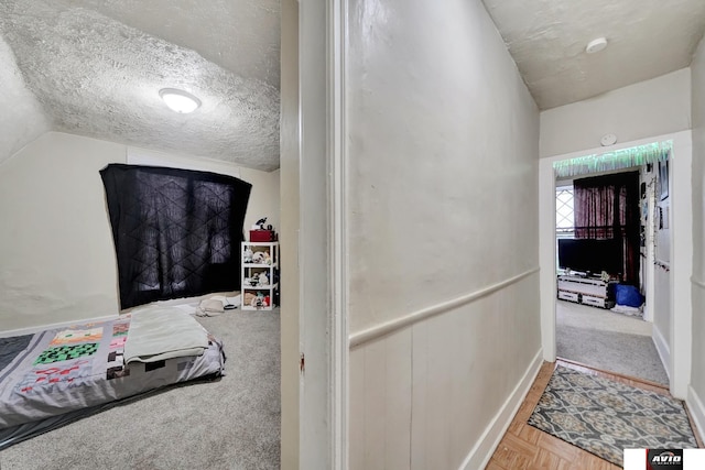 2103 A St, Lincoln, NE 68502 - corridor with baseboards, a textured ceiling, and vaulted ceiling
