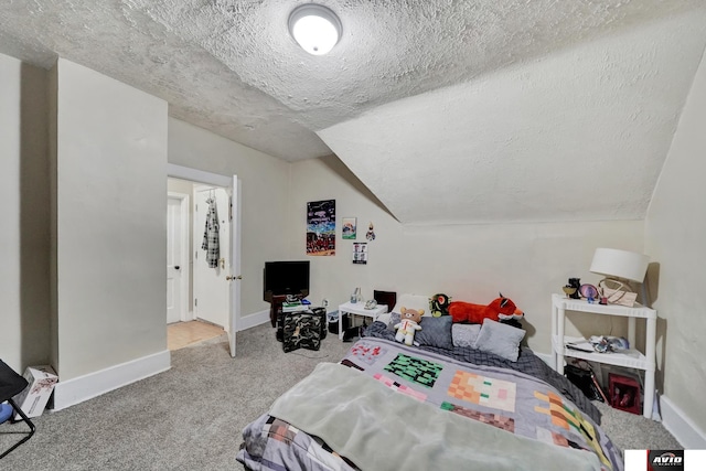 2103 A St, Lincoln, NE 68502 - carpeted bedroom with baseboards, a textured ceiling, and lofted ceiling