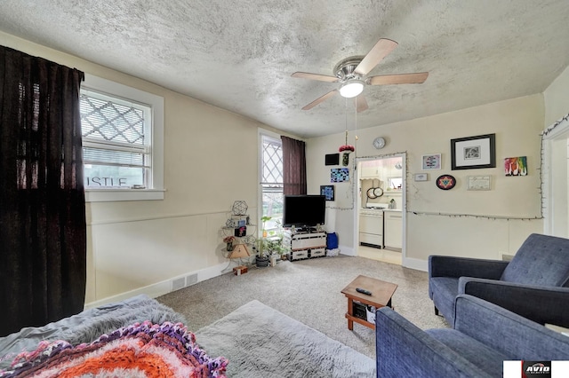 2103 A St, Lincoln, NE 68502 - living room featuring baseboards, ceiling fan, a textured ceiling, and visible vents