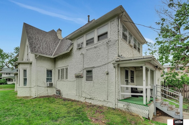 2103 A St, Lincoln, NE 68502 - exterior space featuring fence, roof with shingles, stucco siding, a sunroom, and a yard