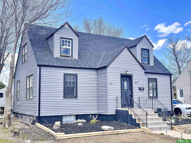 new england style home with a shingled roof