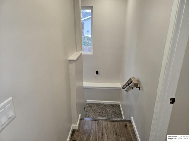 stairway featuring baseboards, visible vents, and wood finished floors