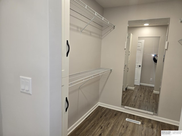 spacious closet featuring wood finished floors and visible vents
