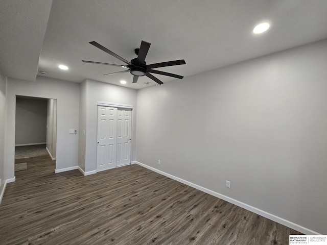 unfurnished bedroom with dark wood finished floors, recessed lighting, a closet, baseboards, and visible vents