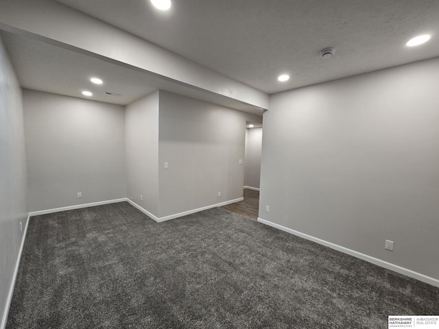 finished basement featuring baseboards, dark colored carpet, and recessed lighting