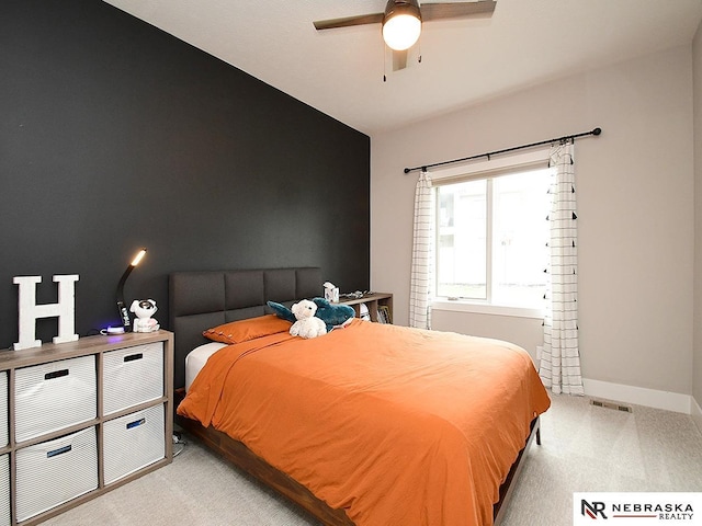 bedroom with baseboards, ceiling fan, carpet flooring, and visible vents
