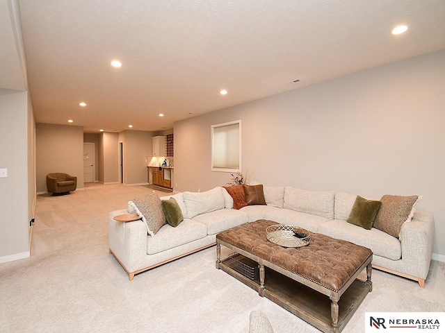 living room featuring recessed lighting and light carpet